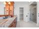 Well-lit bathroom boasts marble countertops, a spacious shower with glass door, and convenient access to a walk-in closet at 3567 Marion Ln., Murrells Inlet, SC 29576