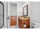 Bathroom with a wooden vanity, granite countertop, decorative mirror, and a tile floor at 3567 Marion Ln., Murrells Inlet, SC 29576