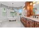 Elegant bathroom with a freestanding tub, cherry cabinets, granite countertops, and a chandelier at 3567 Marion Ln., Murrells Inlet, SC 29576