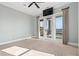 Large bedroom with a ceiling fan, neutral carpet, and patio door overlooking the waterfront at 3567 Marion Ln., Murrells Inlet, SC 29576