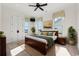 Sun-filled bedroom featuring a large bed, neutral decor, and double doors to a closet at 3567 Marion Ln., Murrells Inlet, SC 29576