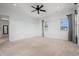 Spacious bedroom with neutral carpet, a ceiling fan, and two windows offering natural light at 3567 Marion Ln., Murrells Inlet, SC 29576