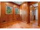 Charming bedroom featuring wood paneling, wood floors, and natural light from two windows at 3567 Marion Ln., Murrells Inlet, SC 29576