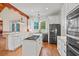 Bright kitchen with white cabinets, granite countertops, and a large island at 3567 Marion Ln., Murrells Inlet, SC 29576