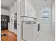 Clean laundry room equipped with modern washer and dryer units, plus bright cabinets at 3567 Marion Ln., Murrells Inlet, SC 29576