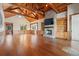 Spacious living room featuring wood floors, a brick fireplace, and ample natural light at 3567 Marion Ln., Murrells Inlet, SC 29576