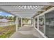 Covered patio with white pergola overlooking the fenced backyard and neighborhood lake at 378 Thistle Ln., Myrtle Beach, SC 29579