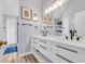 Bright bathroom featuring a dual sink vanity with modern fixtures and a large mirror with decorative wall art at 378 Thistle Ln., Myrtle Beach, SC 29579