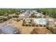 Aerial shot of community pool, pool house, playground, and parking area with surrounding trees at 378 Thistle Ln., Myrtle Beach, SC 29579