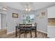 Cozy dining area with a modern ceiling fan, a large window, and attractive wood-look flooring at 378 Thistle Ln., Myrtle Beach, SC 29579