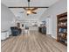 Open-concept living space with vaulted ceiling, exposed wood beam, and wood-look flooring throughout at 378 Thistle Ln., Myrtle Beach, SC 29579