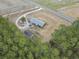 Overhead view of the property and neighboring land including farm fields and mature trees at 4612 Red Bluff Rd., Loris, SC 29569