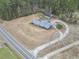 Overhead view of the property and neighboring land showing mature trees surrounding the home at 4612 Red Bluff Rd., Loris, SC 29569