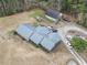 Aerial view of the home and acreage showcasing the metal roof, outbuilding and mature trees at 4612 Red Bluff Rd., Loris, SC 29569