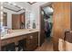 Bathroom with a large well lit mirror, a countertop sink, and an attached walk-in closet at 4612 Red Bluff Rd., Loris, SC 29569