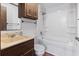 Functional bathroom with a bathtub and shower, a sink and a wooden cabinet for storage at 4612 Red Bluff Rd., Loris, SC 29569