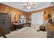 Bedroom with carpet and wood paneled walls and ceiling fan at 4612 Red Bluff Rd., Loris, SC 29569