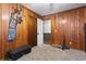 Bedroom with wood paneled walls and neutral carpet at 4612 Red Bluff Rd., Loris, SC 29569