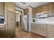 Efficient kitchen space with stainless steel refrigerator, wooden cabinets, and hardwood floors at 4612 Red Bluff Rd., Loris, SC 29569