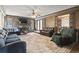 Cozy living room with stone fireplace, wood paneling, and comfortable seating at 4612 Red Bluff Rd., Loris, SC 29569