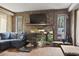 Inviting living room showcasing stone fireplace, mantle, and natural light from the windows at 4612 Red Bluff Rd., Loris, SC 29569