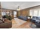 Spacious living room with wood paneled walls, comfortable seating, and a ceiling fan at 4612 Red Bluff Rd., Loris, SC 29569