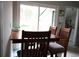 Dining area featuring a wooden table with chairs and natural light from the sliding glass doors at 4649 Tarpon Bay Rd., Myrtle Beach, SC 29579