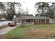 Charming single-story home with brick and vinyl siding, front porch, mature trees, and a well-maintained lawn at 4649 Tarpon Bay Rd., Myrtle Beach, SC 29579