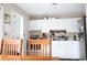 Bright kitchen featuring white cabinets and views of the dining area at 4649 Tarpon Bay Rd., Myrtle Beach, SC 29579