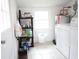 Functional laundry room with washer, dryer, and storage shelves at 4649 Tarpon Bay Rd., Myrtle Beach, SC 29579