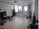 Large living room with tile flooring, a fireplace, ceiling fan, and neutral colors at 4649 Tarpon Bay Rd., Myrtle Beach, SC 29579