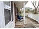 Inviting covered porch featuring comfortable rocking chairs, white railing, and views of the yard at 4649 Tarpon Bay Rd., Myrtle Beach, SC 29579