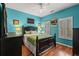 Stylishly decorated bedroom features vibrant blue walls, hardwood floors, and a cozy, inviting atmosphere at 4956 Dory Ct., North Myrtle Beach, SC 29582