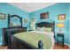 Well-lit bedroom with blue walls, hardwood floors, black furniture, and comfortable, inviting decor at 4956 Dory Ct., North Myrtle Beach, SC 29582