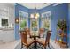 Cozy breakfast nook with bright blue walls, a glass table, and natural light from surrounding windows at 4956 Dory Ct., North Myrtle Beach, SC 29582