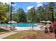 Large community pool with ample seating and lush greenery, providing a relaxing environment at 4956 Dory Ct., North Myrtle Beach, SC 29582