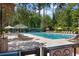 Spacious community pool with multiple lounge chairs and umbrellas, perfect for relaxation and recreation at 4956 Dory Ct., North Myrtle Beach, SC 29582