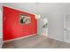 Bright dining room with hardwood floors, pendant lighting, and a vibrant red accent wall at 4956 Dory Ct., North Myrtle Beach, SC 29582