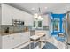 Bright kitchen featuring white cabinetry, stainless steel appliances, and a charming blue backsplash at 4956 Dory Ct., North Myrtle Beach, SC 29582