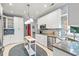 Well-lit kitchen with stainless steel appliances, white cabinetry, blue backsplash, and modern fixtures at 4956 Dory Ct., North Myrtle Beach, SC 29582