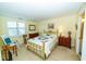 Cozy bedroom features a brass bed frame, matching nightstands and rocking chair at 5001 Little River Rd. # E-407, Myrtle Beach, SC 29577