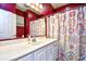 This bathroom features a large mirror, patterned shower curtain, and white sink and cabinets at 5046 Belleglen Court # 101, Myrtle Beach, SC 29579