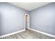 An empty bedroom with gray walls, white trim and gray toned wood flooring and a closet at 5046 Belleglen Court # 101, Myrtle Beach, SC 29579