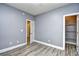 Empty bedroom featuring gray walls, light wood-look floors, white trim and a walk in closet at 5046 Belleglen Court # 101, Myrtle Beach, SC 29579