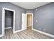 This bedroom has neutral paint and wood-look floors with access to a closet at 5046 Belleglen Court # 101, Myrtle Beach, SC 29579