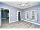 This bedroom features wood-look flooring, a ceiling fan, and ample natural light at 5046 Belleglen Court # 101, Myrtle Beach, SC 29579