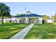 Community clubhouse with a walkway, manicured lawn, and an American flag at 5046 Belleglen Court # 101, Myrtle Beach, SC 29579