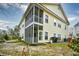 View of the screened in porch and back of a two-story house at 5046 Belleglen Court # 101, Myrtle Beach, SC 29579