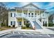 Inviting two-story condo with charming yellow siding, white railings, and well-maintained landscaping at 5046 Belleglen Court # 101, Myrtle Beach, SC 29579