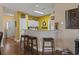 Kitchen with barstool seating, seamlessly connected to the living area with modern finishes at 5070 Windsor Green Way # 204, Myrtle Beach, SC 29579